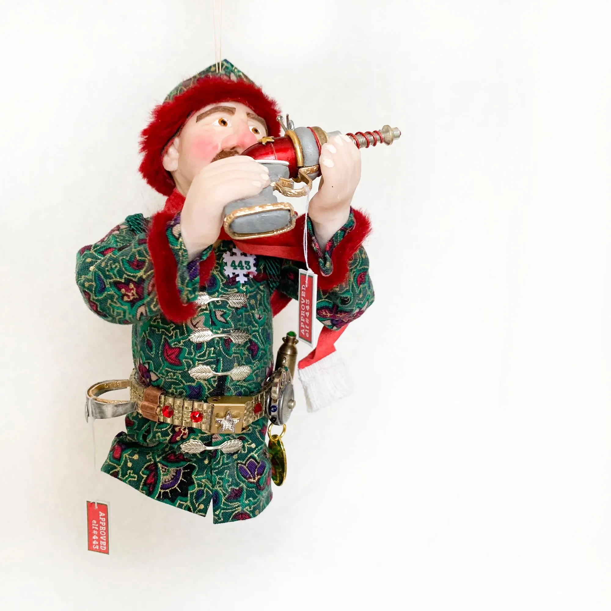 Christmas ornament - Spaceman Elf #443 inspecting a Ray Gun