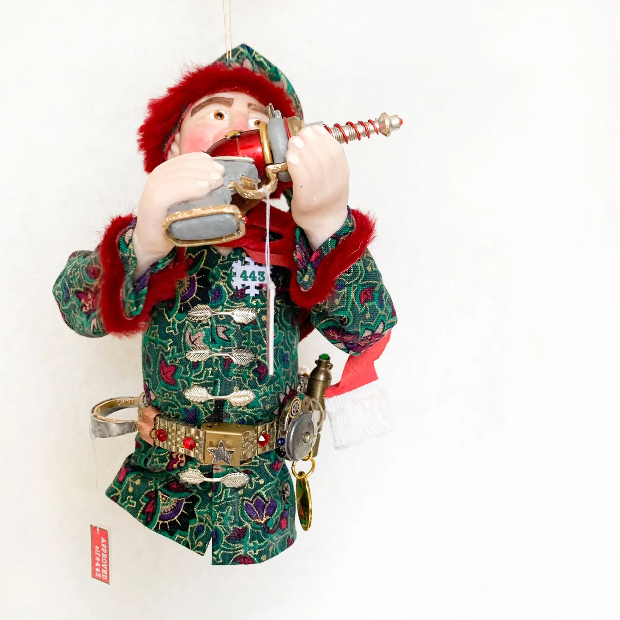 Christmas ornament - Spaceman Elf #443 inspecting a Ray Gun